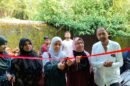 Chief Guest Anjum Parveen cuts the ribbon for the new building. Speakers emphasize the role of parents, discipline, and a positive home environment in shaping a child's future.