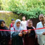 Chief Guest Anjum Parveen cuts the ribbon for the new building. Speakers emphasize the role of parents, discipline, and a positive home environment in shaping a child's future.